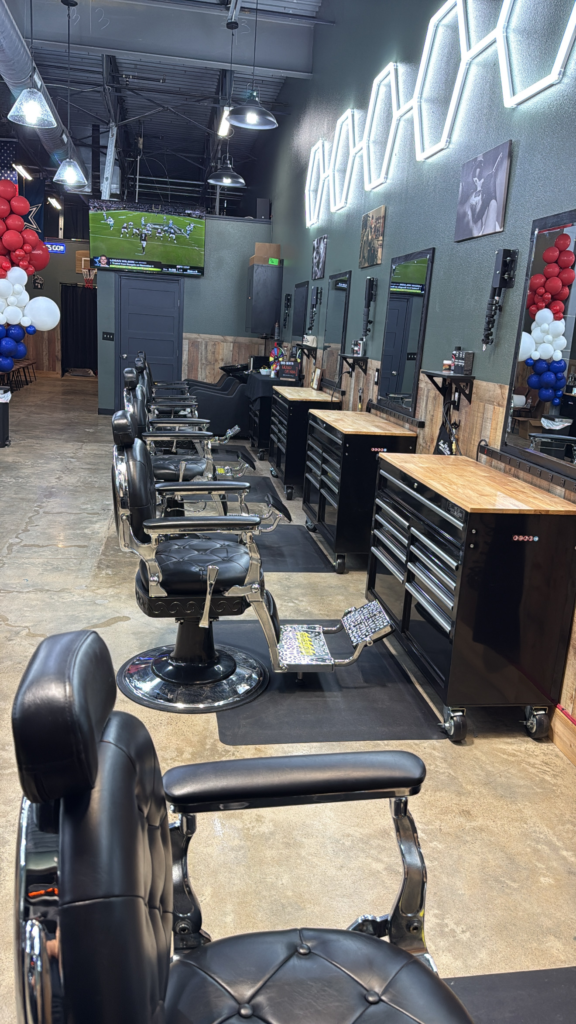 A row of barber chairs and grooming stations at the Beard Boss Barbershop Heath location.