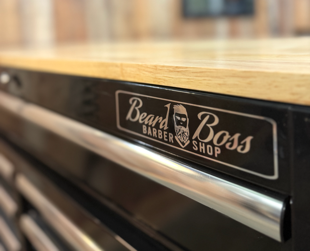 A grooming station with a Beard Boss decal on it at the Beard Boss Barbershop in Rockwall.